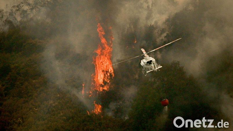 Ein Löschhubschrauber wirft Wasser über einem Feuer in der spanischen Provinz Ourense ab. Bild: Adrián Irago/EUROPA PRESS/dpa