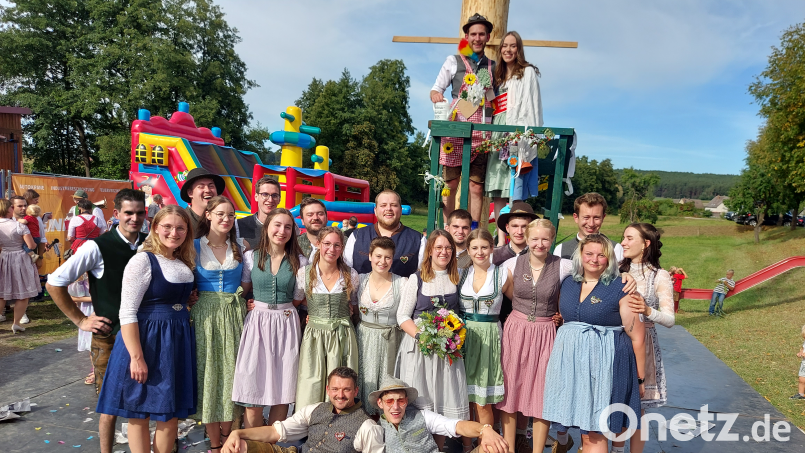 Das neue Oberkirwapaar Lorena Hollweck und Jonas Fronhofer auf dem Hochsitz - vor ihnen die Kirwapaare. Im Hintergrund zu sehen, der Kinder-Magnet, die riesengroße Piratenschiff-Hüpfburg. Bild: rab