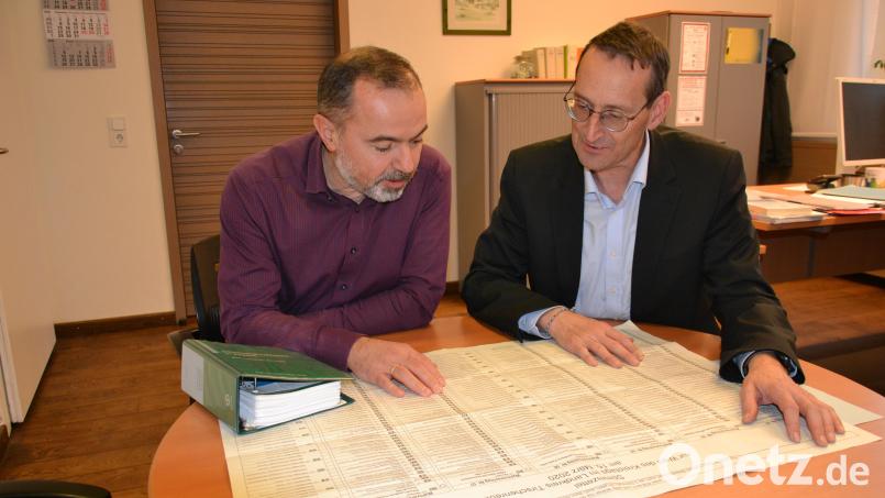 Bei Kreiswahlleiter Markus Zapf (rechts) und seinem Stellvertreter Thomas Schraml laufen die Fäden der Organisation zusammen. Ähnlich groß wie der Stimmzettel zur Kreistagswahl 2020, den sie hier zu Vergleichszwecken vor sich ausgebreitet haben, wird auch die Liste im März 2026 sein. Statt sieben Listen gibt es diesmal acht. Bild: as