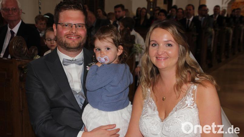 Carolin und Ralf Pöllmann vor dem Traualtar in der Tirschenreuther Pfarrkirche. Mit dabei war auch Töchterchen Emma. Bild: kro