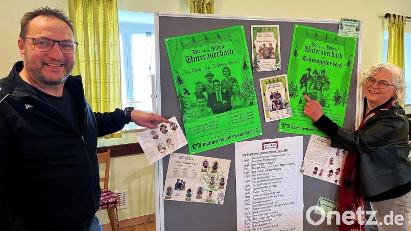 Norbert Lehner und Monika Graf deuten auf eine ihre Lieblingsrollen. Norbert Lehner auf Schippe in "Gspenstermacher" und Monika Graf auf Paula in "Schmugglerbazi". Die beiden spielen seit Jahrzehnten auf der kleinen Bühne im Unterauerbacher Pfarrheim. Bild: ihl