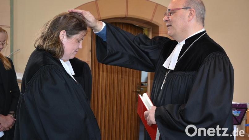 Durch Handauflegen führte Dekan Thomas Guba Pfarrerin Mareike Kraemer in ihr neues Amt ein. Bild: jr