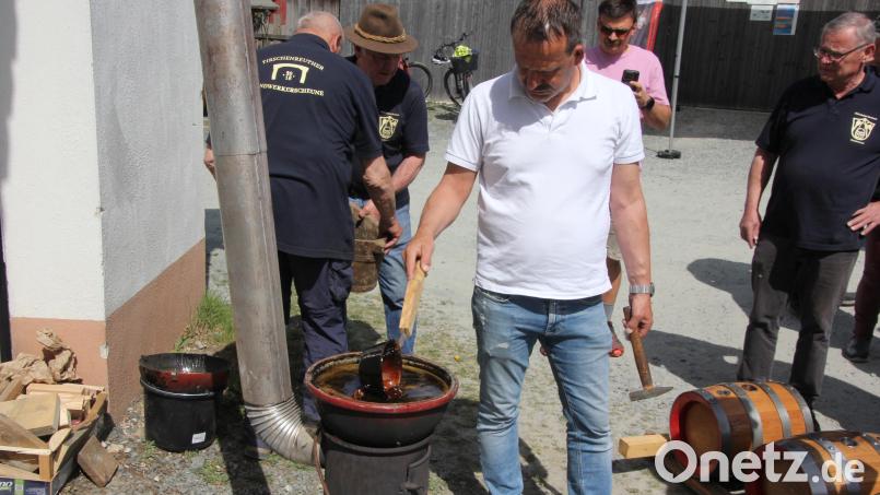 Das Baumpech wird auf einem Holzofen erhitzt. Bild: Konrad Rosner