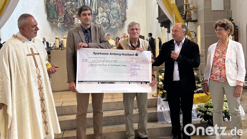Der Förderverein zur Kirchen- und Orgelsanierung überreicht einen Scheck über 60.000 Euro an Pfarrer Josef Irlbacher und Kirchenpfleger Christian Baldauf. Das Geld unterstützt bei der Fundamentsanierung der Kirche Hl.-Dreifaltigkeit in Amberg. Bild: Jürgen Baldauf