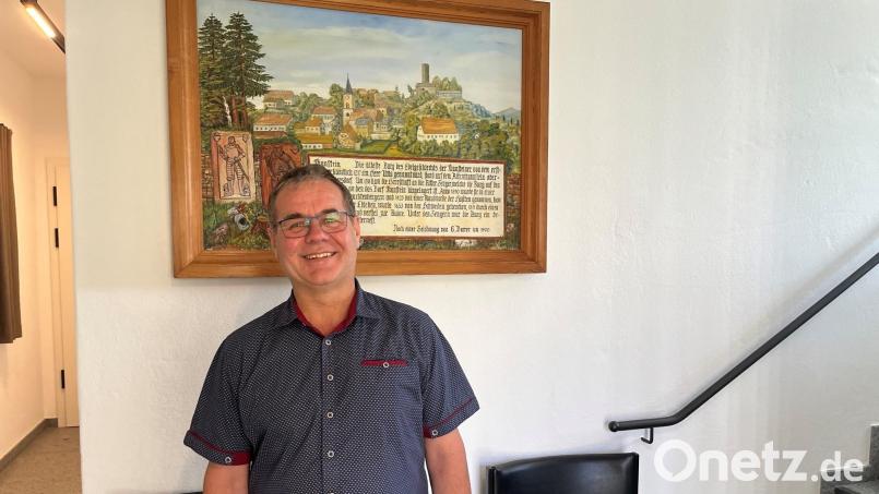 Der neue Thansteiner Bürgermeister, Michael Brandl, steht im Eingang des Bürgerhauses vor einer historischen Zeichnung Thansteins. Bild: ihl
