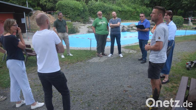 Wasserwart Andre Wenzel (im Vordergrund rechts) und Bürgermeisterin Tanja Kippes (rechts hinten) erläutern den Bauausschussmitgliedern die Maßnahmen zur Mängelbehebung der Kinderplanschbecken, die für die Kleinen ab Mitte Juli wieder zugänglich sein sollen. Bild: Ernst Frischholz