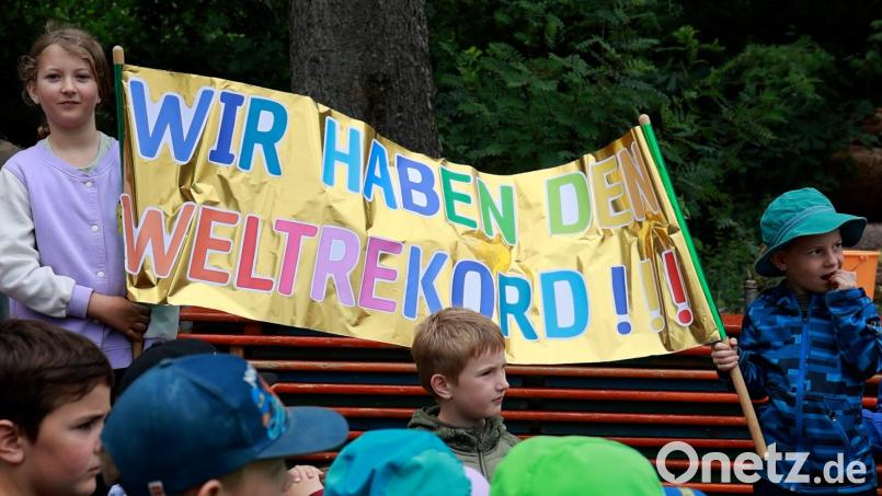 Der Jubel ist groß: Zwei Kindergartenkinder präsentieren nach der Rekordverkündung stolz ihr Transparent „Wir haben den Weltrekord“. Bild: Roland Wellenhöfer