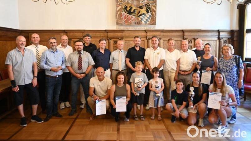 So sehen die "Sieger" des Amberger 24-Stunden-Schwimmens aus. Oberbürgermeister Michael Fritz (Mitte) verteilte großzügig Urkunden und dankte allen Sponsoren und Helfern. Bild: Simon Hauck, Stadt Amberg