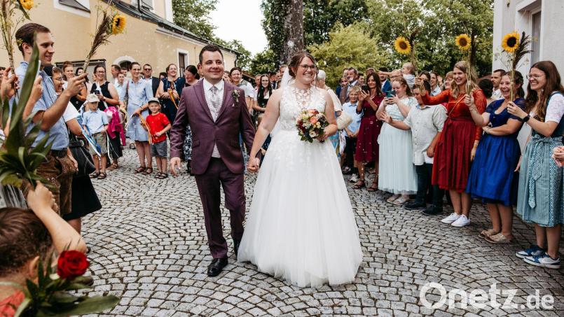 Das Brautpaar Christian Mösbauer und Doris Drexler inmitten der Gratulanten vor der Hiltersrieder Kirche. Bild: easyandflow