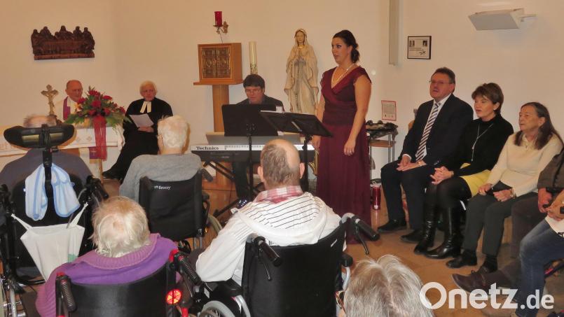 In der Hauskapelle des BRK-Seniorenheims Vilseck versammeln sich zur Weihnachtsfeier Bewohner und Personal (hinten, von links): Pfarrer Josef Wittmann, Pastor Martin Valeske, Gerhard Kraus am Keyboard, Mezzosopranistin Eleanor Nemeth Patton, Bürgermeister Hans-Martin Schertl mit Frau Gerlinde. Bild: rha