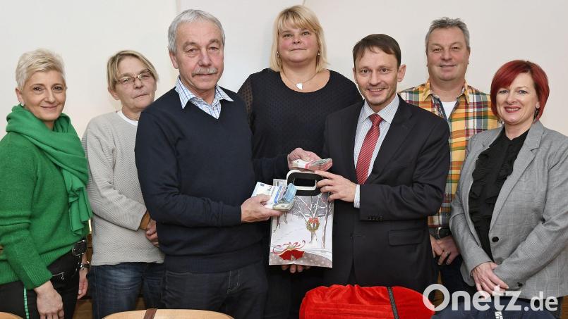 Gerd Donhauser übergibt den Erlös der Weihnachtstombola der Marktkaufleute an Bürgermeister Jens Meyer. Die Aktion unterstützen (hinten von links) Claudia Heindl, Nadja Rothballer, Gertrud Wittmann (Eventmanagerin der Stadt Weiden), Johannes Heindl und Daniela Margraf von der Arbeitsgemeinschaft Christkindlmarkt der Marktkaufleute. Bild: Petra Hartl