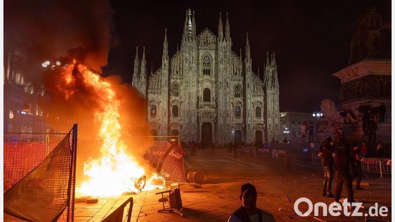 Vor dem Mailänder Dom brannte am Samstagabend ein Feuer. Bild: Stefano Porta/LaPresse/AP/dpa