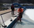 Einer sichert, der andere sägt die Eisschicht auf. Obwohl die Sonne scheint, bibbern Horst Lindner (links) und Benjamin Höllerer (rechts) bei minus 11 Grad Celsius im Freibad. Der Druck, der durch das Eis entsteht, kann die Fliesen im Freibad zum Bersten bringen. 	Bild: exb