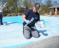 Bevor das Becken der Freizeitanlage mit Wasser gefüllt wird, verpassen ihm Stefan Meier und Michael Girke einen neuen Anstrich - eine schweißtreibende Arbeit in der warmen Frühlingssonne.	Bild: Schönberger