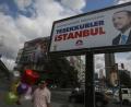 Bild: Emrah Gurel/AP/dpa
Ein Plakat mit einem Bild des Staatspräsidenten Erdogan ist ein Tag nach den Wahlen in der Türkei vor einem bewölkten Himmel zu sehen. Trotz Manipulationsvorwürfen der Opposition hat sich der türkische Staatspräsident noch vor dem Ende der Auszählung zum Sieger der Präsidentenwahl erklärt.