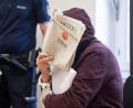 Bild: Marijan Murat/dpa
Am Mittwoch, 23. September 2020, vor dem Landgericht Stuttgart: Der Angeklagte in einem Mordprozess, der 25 Jahre nach der Tat beginnt, sitzt in einem Saal des Landgerichts und hält sich eine Zeitung vor sein Gesicht.