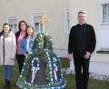 Bild: ads
Als Familienaktion gestaltet sich das Schmücken der alten Glocke im Pfarrgarten von St. Konrad für Manuela Weigl (hinten) und ihre beiden Töchter Leonie und Johanna (vorne, von links). Pfarrer Michael Jakob freut sich wie die Passanten an der geschmückten Osterglocke – heuer in den Bayernfarben.