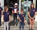 Bild: bkr
Lena, Marie, Annika, Elias und Marlene (von links) von den Feuerdrachen mit der Spendendose vom Dorfladen.