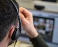 Symbolbild: Sebastian Gollnow/dpa
Ein junger Mann, der ein Headset trägt, nimmt an einer Videokonferenz teil.