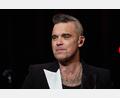 Archivbild: Georg Wendt/dpa
Popsänger Robbie Williams steht auf der Bühne. Foto: Georg Wendt/dpa/Archivbild