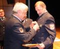 Bild: jma
Kreisbrandrat Fredi Weiß steckt Rudolf Schwindl das Ehrenkreuz in Silber an.
