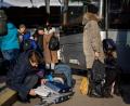 Bild: Bernat Armangue/AP/dpa
Ukrainische Bürger bereiten sich an einem Bahnhof im Westen der Ukraine vor, in einen Bus nach Polen einzusteigen.