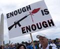 Symbolbild: Jose Luis Magana, dpa
Anti-Waffen-Protest in den USA: Ein Demonstrant trägt ein Plakat mit der Aufschrift „Enough is Enough“ (genug ist genug).