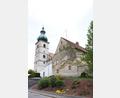 Bild: flt
Ortsprägend steht das Kooperatorhaus (rechts) direkt neben der katholischen Kirche Mariä Himmelfahrt in Beidl. Dazwischen liegt der Friedhof der kath. Kirche.