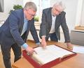 Bild: Thomas Graml, Stadt Amberg/exb
Oberbürgermeister Michael Cerny (links) und Stadtarchivar Dr. Andreas Erb blättern im Goldenen Buch der Stadt, das heuer 100 Jahre alt wird.