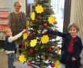 Bild: jr
Kinderschutzbund-Vorsitzende Nina Neumann mit ihren Kindern Karolina (rechts) und Gabriel, die die Wunschsterne am Christbaum in der Sparkasse in Mitterteich befestigen. besteht dazu Zeit.