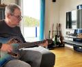 Bild: kle
Egid Spies sitzt mit seiner Gitarre auf dem heimischen Sofa. Seit einer Covid-Infektion hat er starke kognitive Probleme. Plötzlich fielen ihm die über Jahrzehnte erlernten Gitarrengriffe nicht mehr ein.