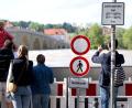Bild: Sven Hoppe/dpa
Menschen schauen sich in der Altstadt am Donauufer hinter einer Schutzwand das Hochwasser an.