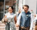 Bild: Kristina Erker/exb
Nach ihrer Trauung in Illschwang gehen Christina Stollner und Marc Simmendinger durch ein Splaier mit Rosen..