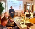 Bild: Krones
Erhard Ströhl (stehend) stellt dem Schnaittenbacher Stadtrat die Mentor-Lesepaten in der AOVE vor.