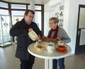 Bild: Archiv Helga Katrin Stano
Pfarrer Haußmann, der ein Kenner der Schwarzenfelder Tonwaren ist und auch schon darüber referierte, mit Helga Katrin Stano, deren Mutter noch in der Heferlbude arbeitete. Sie trug mit Unterstützung von Herrn Linzmeier eine stattliche Sammlung von Steingutstücken aus der Tonwarenfabrik zusammen, die man im Eingangsbereich des Schwarzenfelder Rathaus sehen kann. In Pfarrer Haußmanns Hand eine Schüssel (Alltagsgeschirr) mit Schablonendekor. Die Tasse im Vordergrund ist das älteste Exponat und dürfte von 1905 sein. Der Krug rechts ist aus den 20er-30er Jahren. Tasse mit Untertasse ist minderwertige Kriegsware. Der Obstteller und die Nippesfigur haben Laufglasur.