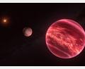 Bild: M. Kornmesser/ESO/dpa
Künstlerische Darstellung des Systems um den Stern CD-35 2722. Das System besteht aus einem Stern, einem Braunen Zwerg und einem Satelliten.