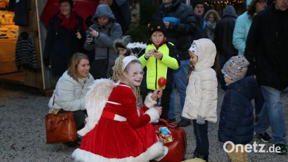 Ein Weihnachtsengel verteilt Geschenke an die kleine Marktbesucher. Bild: rw