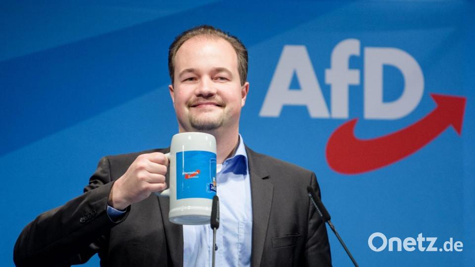 Martin Sichert, Landesvorsitzender der AfD in Bayern, prostet beim politischen Aschermittwoch der AfD in Osterhofen mit einem Maßkrug den Parteianhängern zu. Bild: Matthias Balk/dpa