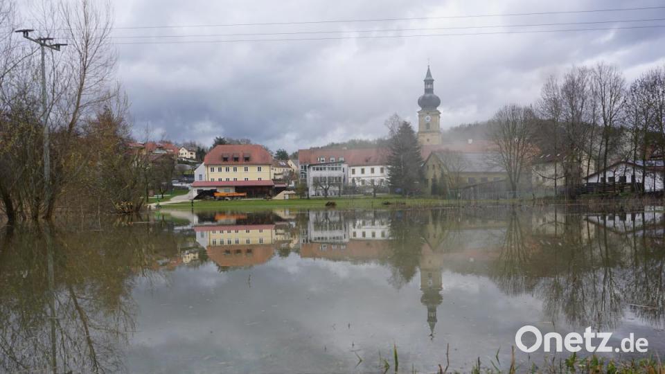 In Ensdorf (Kreis Amberg-Sulzbach) steht der Kirwaplatz komplett unter Wasser. In dem neu entstandenen &quot;See&quot; spiegelt sich das Kloster. Bild: jut
