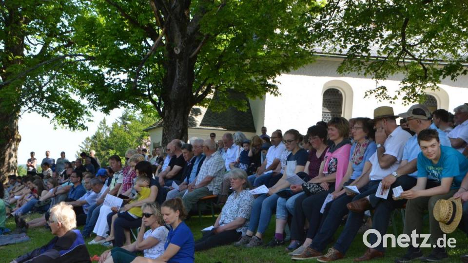 Zum Open-Air-Gottesdienst auf dem Hügel lassen sich die Besucher unter dem Schatten der Bäume nieder. Bild: dob