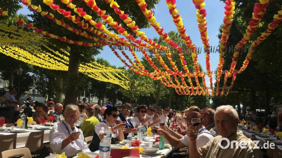 Die Amberger erheben ihr Glas auf die Taulada, eine traditionelle Mahlzeit, zu der auf dem Platz Tourny für rund 800 Menschen eingedeckt wurde. Bild: san