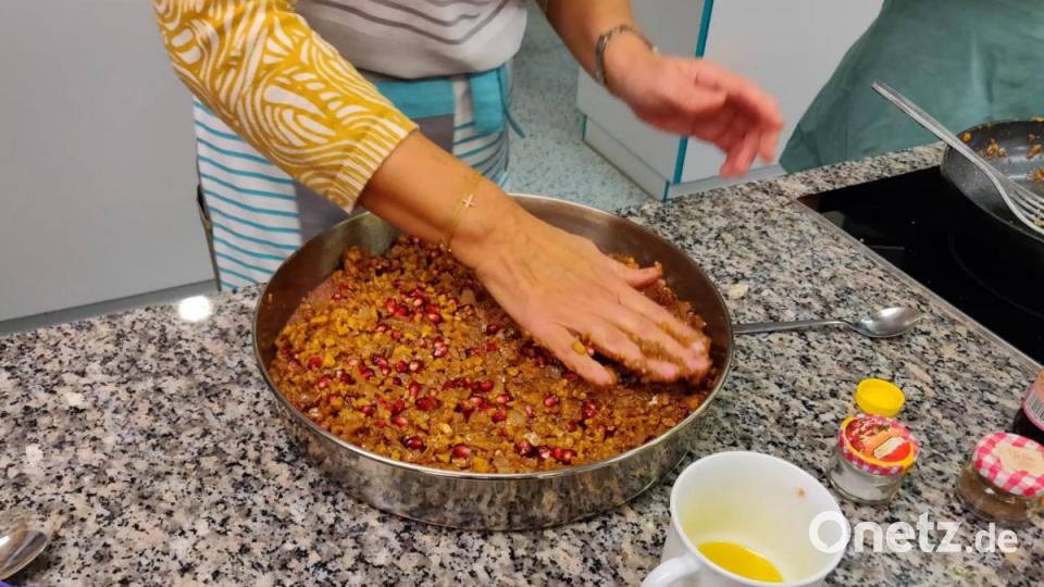 Arabisch kochen: Kibbeh bi-siniyeh wird hergestellt. Der Boden und der Deckel bestehen aus pürierten Rindfleisch und Bulgur. Die Füllung aus Walnüssen, Granatapfel-Kernen und Zwiebeln. Bild: td