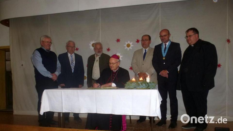 Der Bischof beim Eintrag ins Goldene Buch. Bild: mad