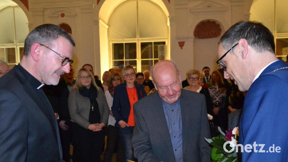 Bürgermeister Bernd Sommer (rechts) bei der Verleihung der Urkunde an Johann Müller, links Stadtpfarrer Thomas Vogl. Bild: pz