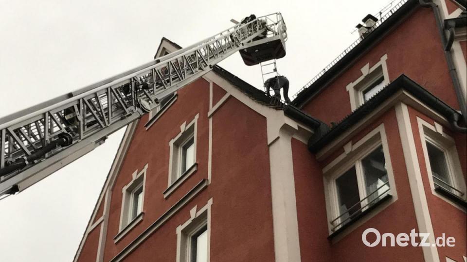 Ein Feuerwehrmann überprüft die Schäden am Dach eines Anwesens in der Johannisstraße. Bild: Gabi Schönberger