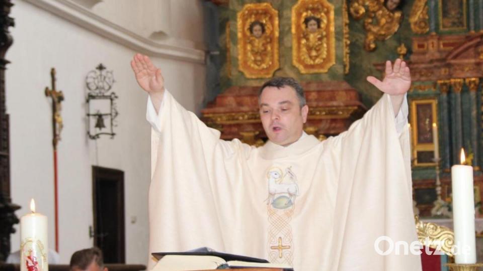 Neupriester Benjamin Raffler spendet zum Abschluss seiner ersten Messfeier in St. Georg Amberg den Primizsegen. Bild: ads