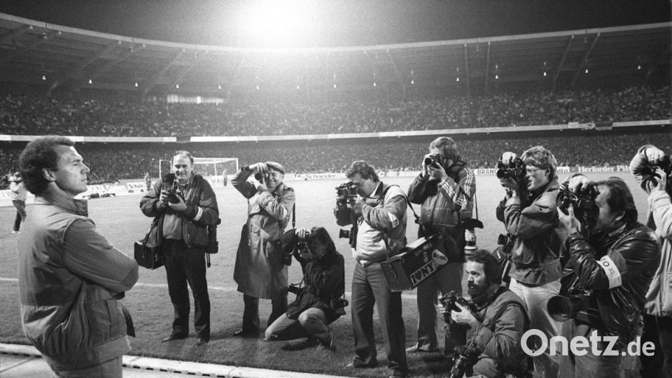 DFB-Teamchef Franz Beckenbauer steht vor 61.000 Zuschauern im Köln-Müngersdorfer Stadion im Blickpunkt einer Schar von Fotografen. Die deutsche Fußballnationalmannschaft gewann das WM-Qualifikationsspiel gegen Schweden mit 2:0. Bild: Franz-Peter Tschauner