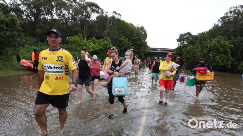 Menschen auf einer überschwemmten Straße im australischen Chinderah. Bild: Jason O’brien/AAP/dpa