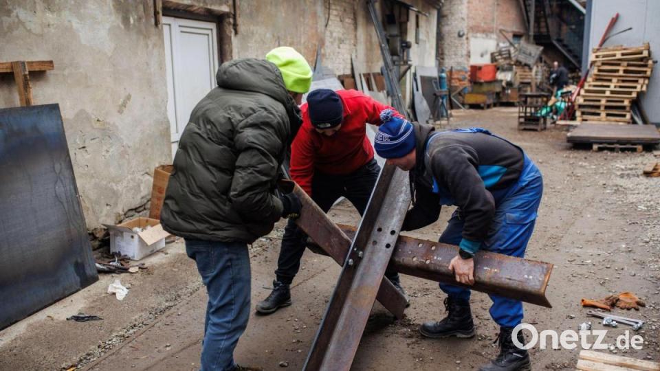 Drei Männer bauen in einer Metallfabrik in Lwiw einen Tschechenigel. Bild: Alejandro Martínez Vélez/EUROPA PRESS/dpa