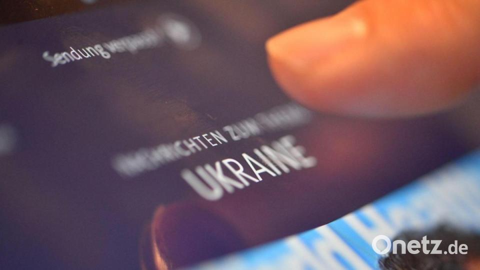 Ein Mann schaut sich auf einem Tablet Nachrichten zum Thema Krieg an. Bild: Lino Mirgeler/dpa